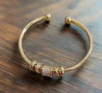 Adjustable bracelet with golden charms